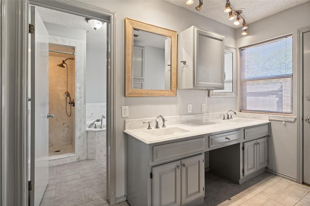 7508 Ravenswood Road Granbury, TX 76049 - Photo 34 of 40 a bathroom with a sink double vanity and a mirror