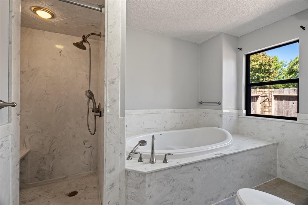 7508 Ravenswood Road Granbury, TX 76049 - Photo 35 of 40 a white bath tub sitting next to a shower