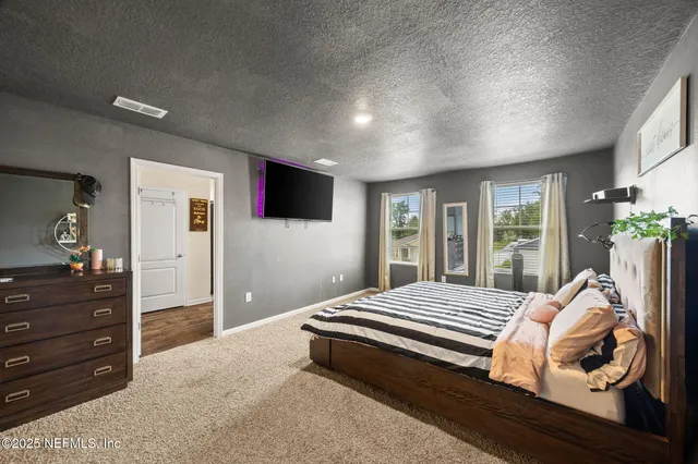 a bedroom with a large bed and a window