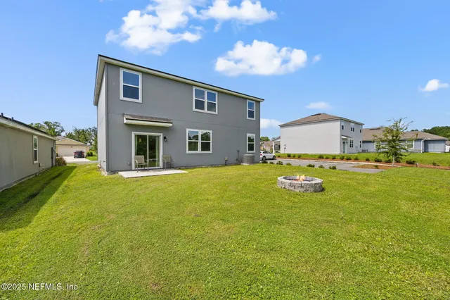 a swimming pool with outdoor seating and yard