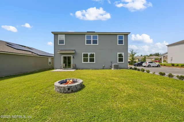 a house view with swimming pool and garden space