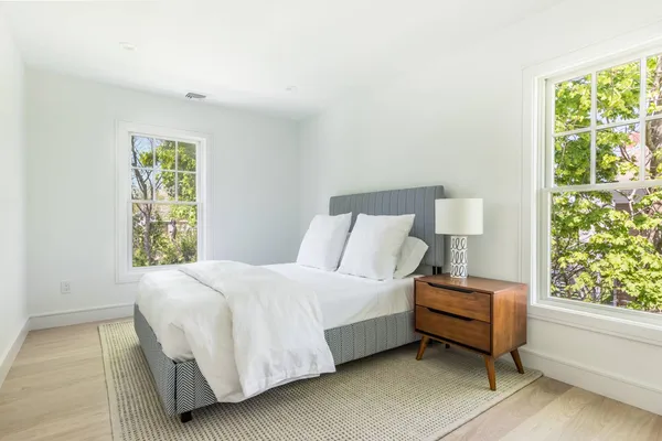 a bedroom with a bed lamp and window