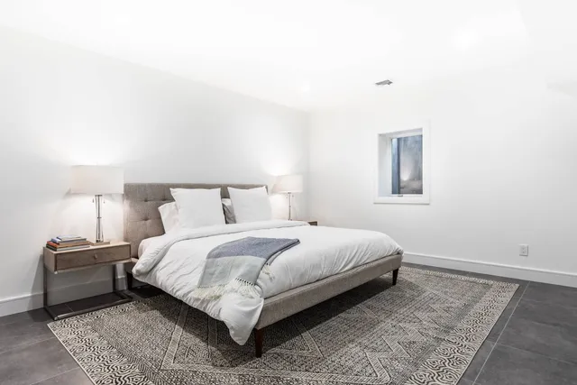 a bedroom with a bed and a night stand