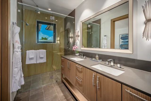a bathroom with a sink mirror and a shower