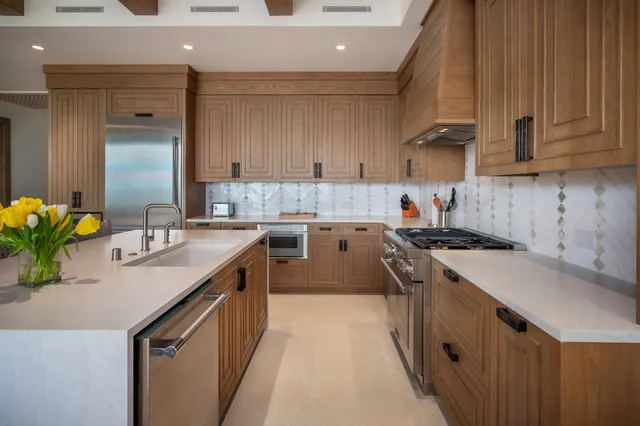 a kitchen with a sink stove and cabinets
