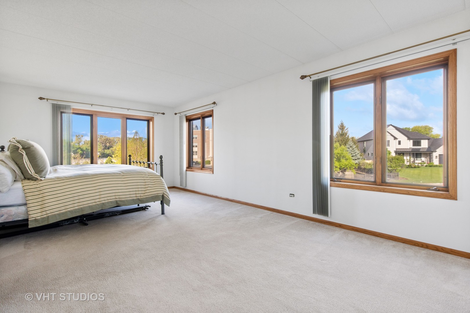 201 West Brush Hill Road, Unit 102 Elmhurst, IL 60126 - Photo 12 of 18 a bedroom with a bed and a large window