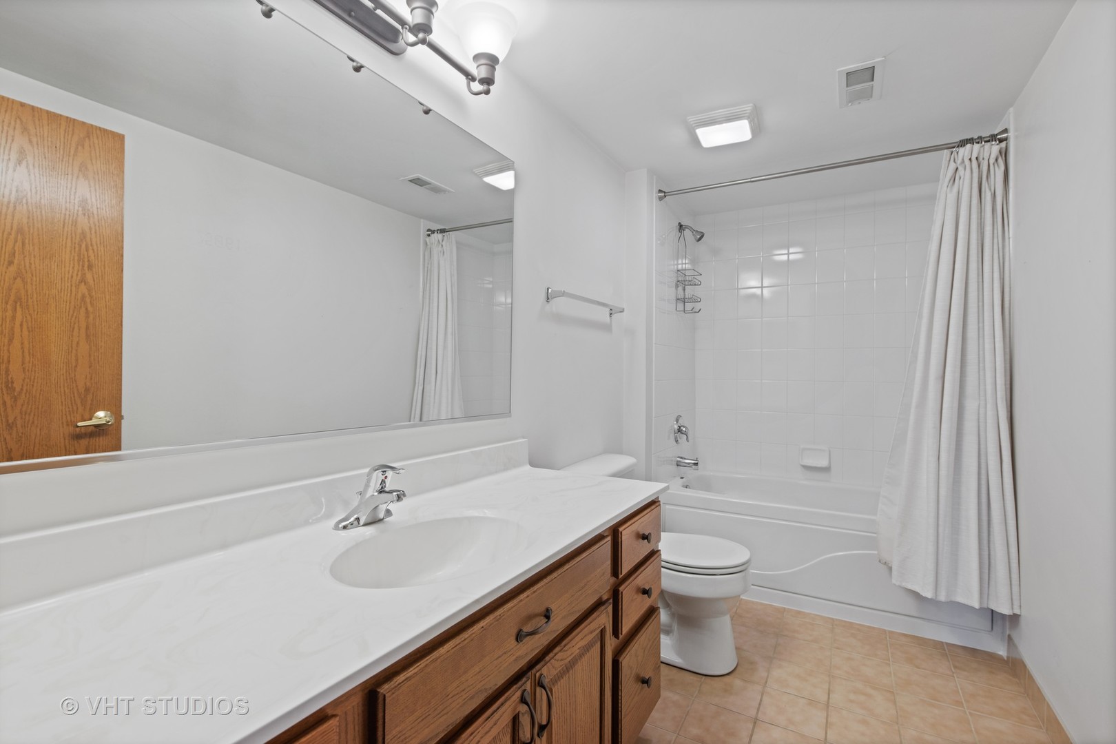 201 West Brush Hill Road, Unit 102 Elmhurst, IL 60126 - Photo 15 of 18 a bathroom with a sink a toilet and shower