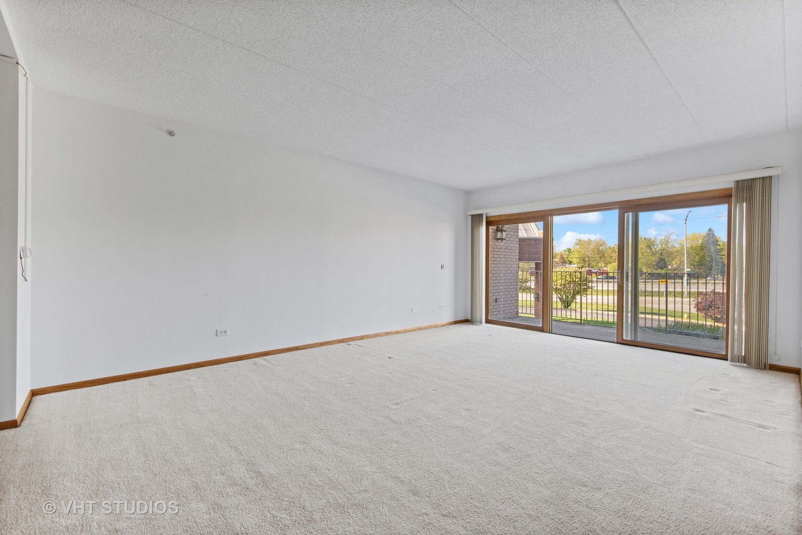 201 West Brush Hill Road, Unit 102 Elmhurst, IL 60126 - Photo 2 of 18 a view of an empty room with a window