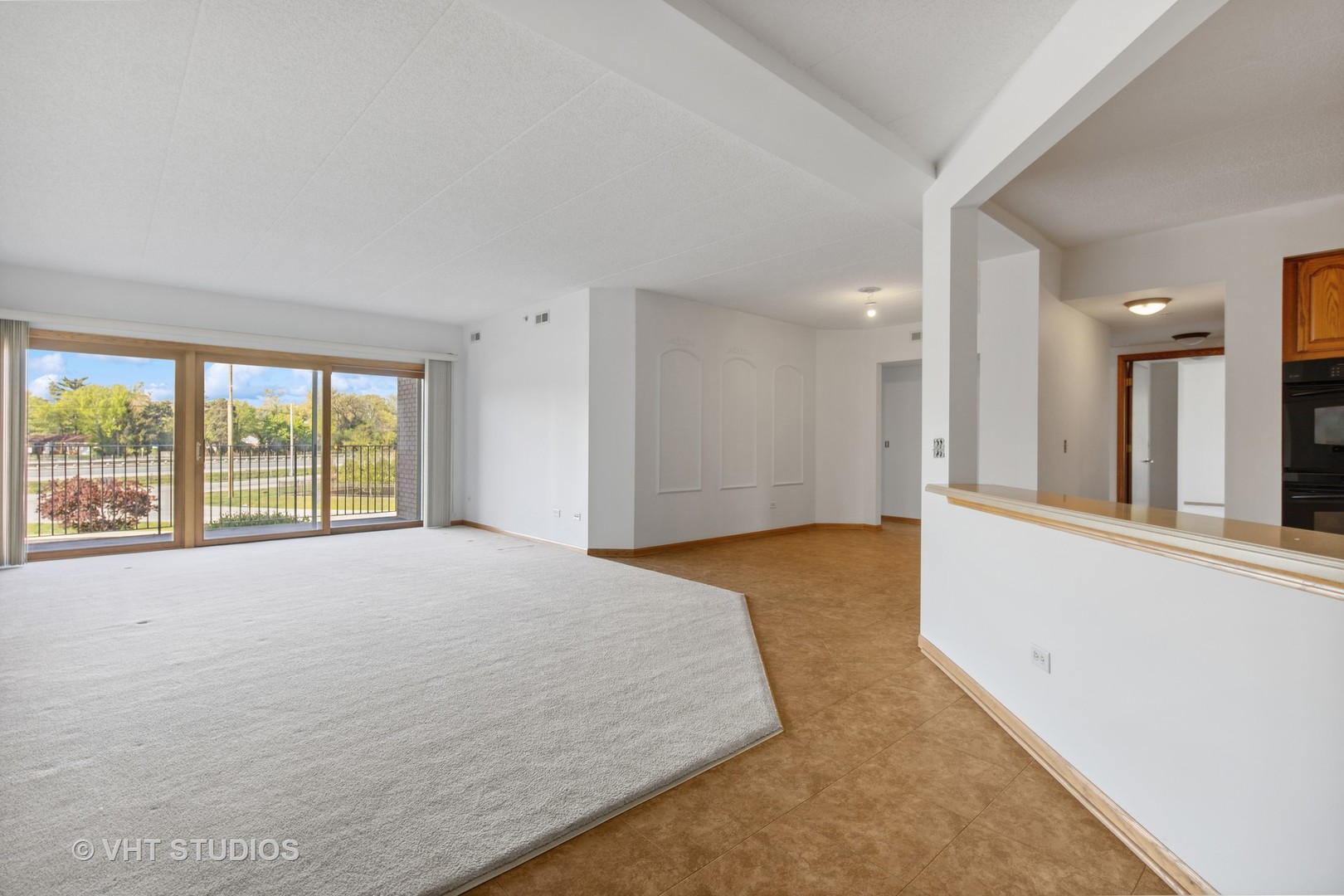 201 West Brush Hill Road, Unit 102 Elmhurst, IL 60126 - Photo 4 of 18 a spacious bedroom with a large bed and a large window