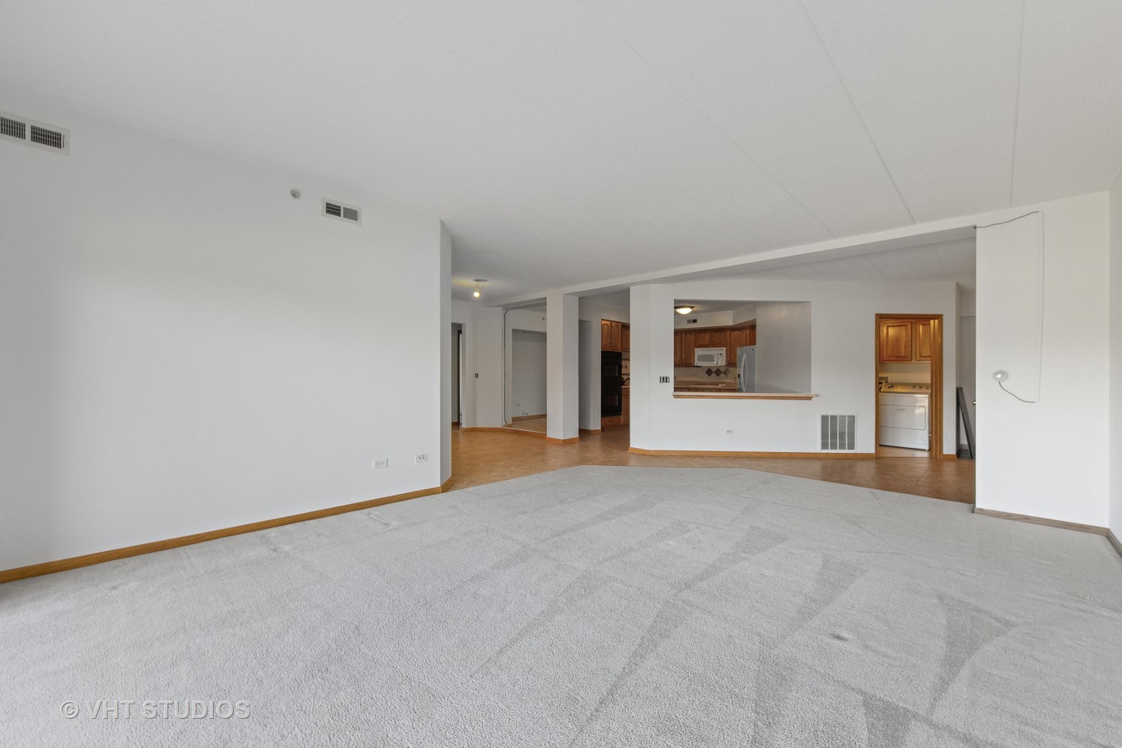 201 West Brush Hill Road, Unit 102 Elmhurst, IL 60126 - Photo 8 of 18 a view of a livingroom with an empty space and a window