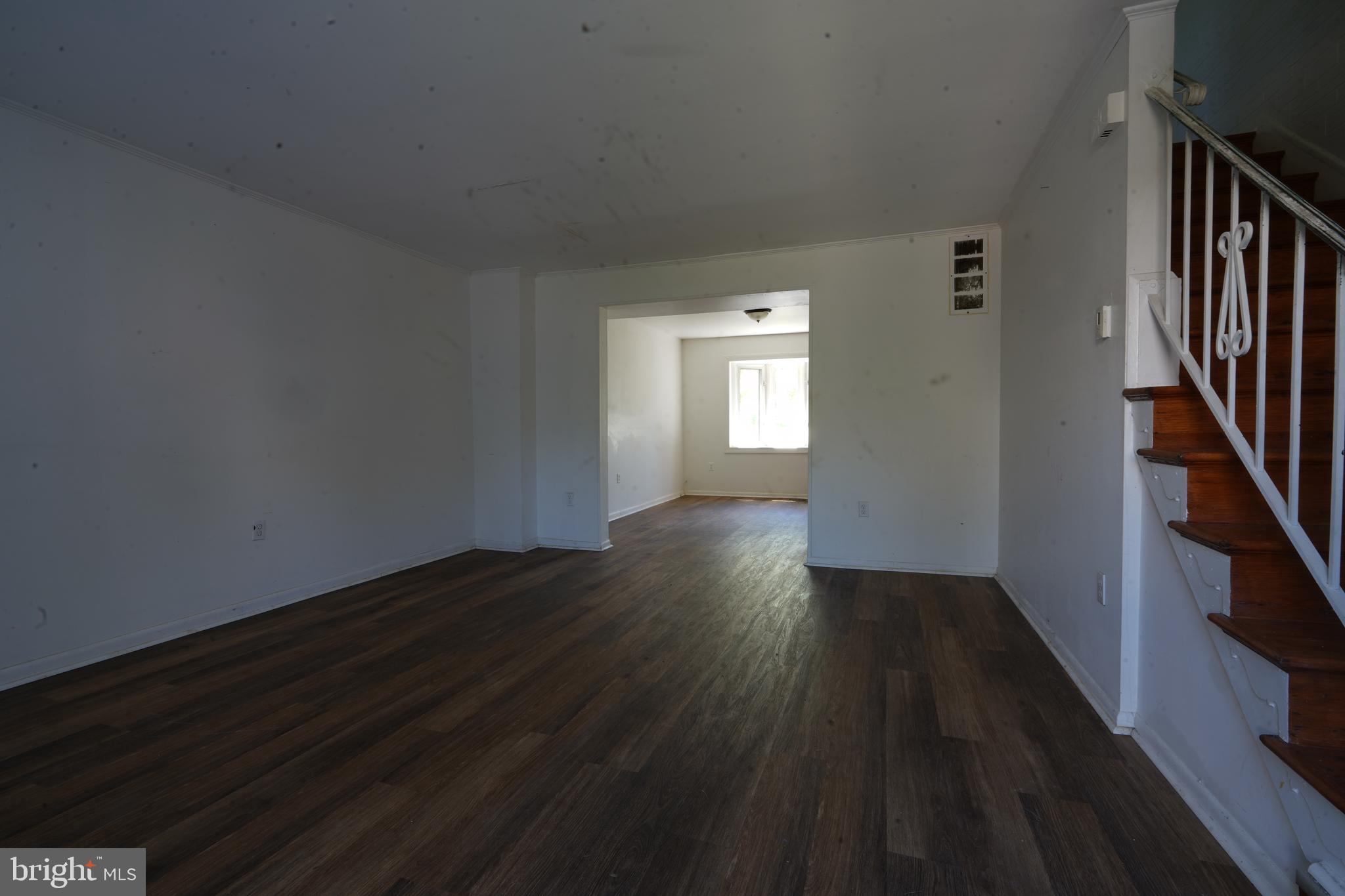 12836 Claxton Drive, Unit 4E Laurel, MD 20708 - Photo 4 of 13 a view of an empty room with wooden floor and a window