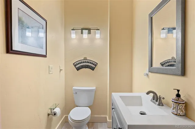 a white toilet sitting next to a bathroom sink
