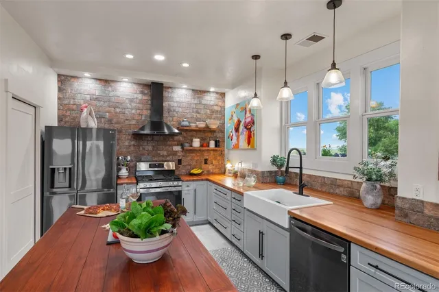 a kitchen with sink a counter and cabinets