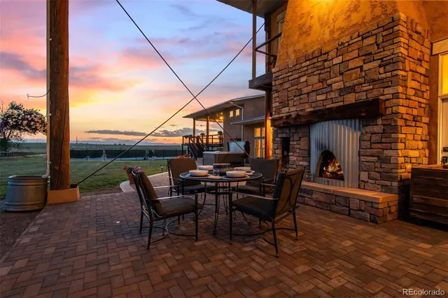 a view of a patio with a table chairs and a fire pit