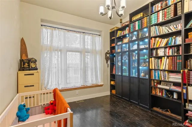 a living room with fish tank and a bookshelf