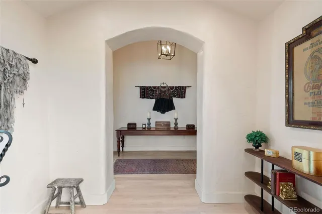 a living room with furniture and a mirror
