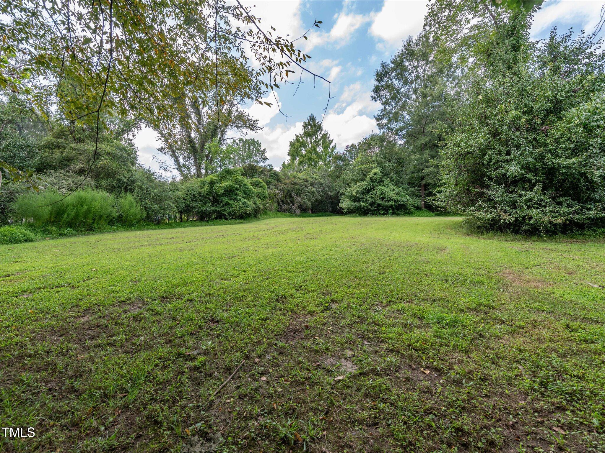 3320 High Gate Road Raleigh, NC 27603 - Photo 23 of 40 Continued flat backyard behind the fence for a total lot of 1.05 acres!