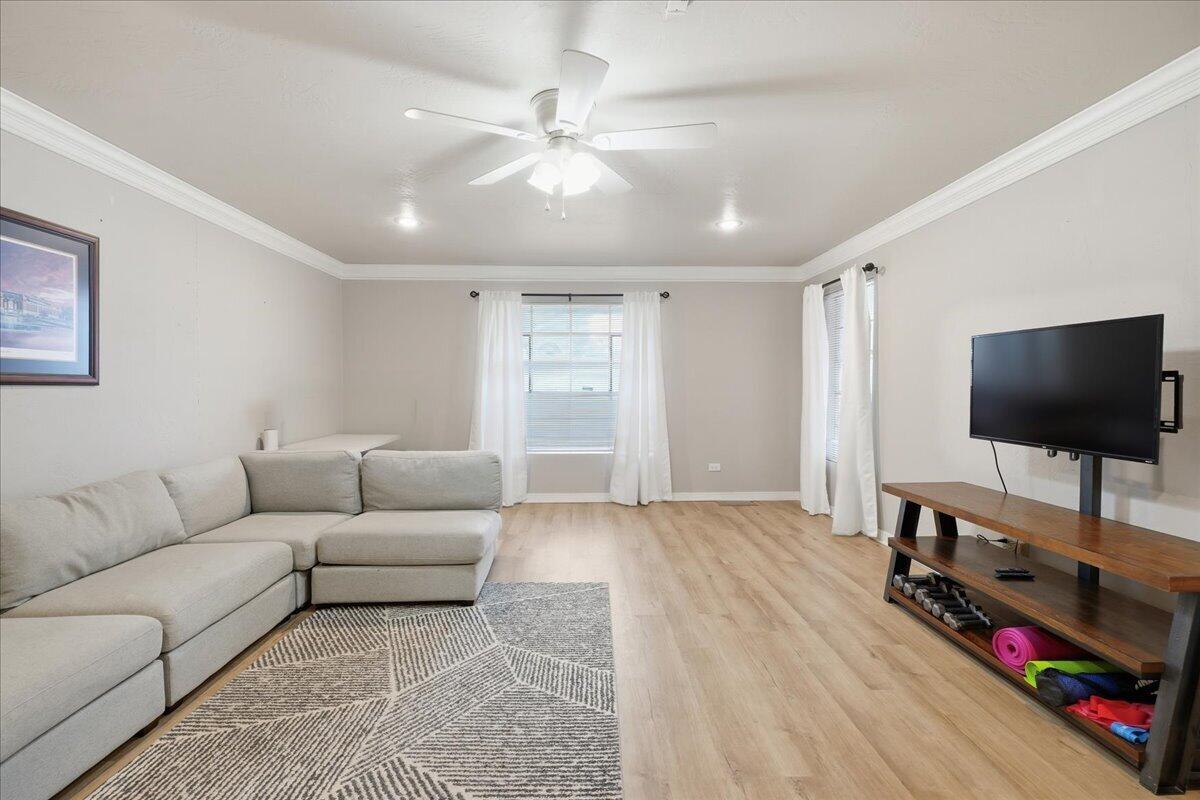 3607 27th Street Lubbock, TX 79410 - Photo 11 of 30 a living room with furniture and a flat screen tv