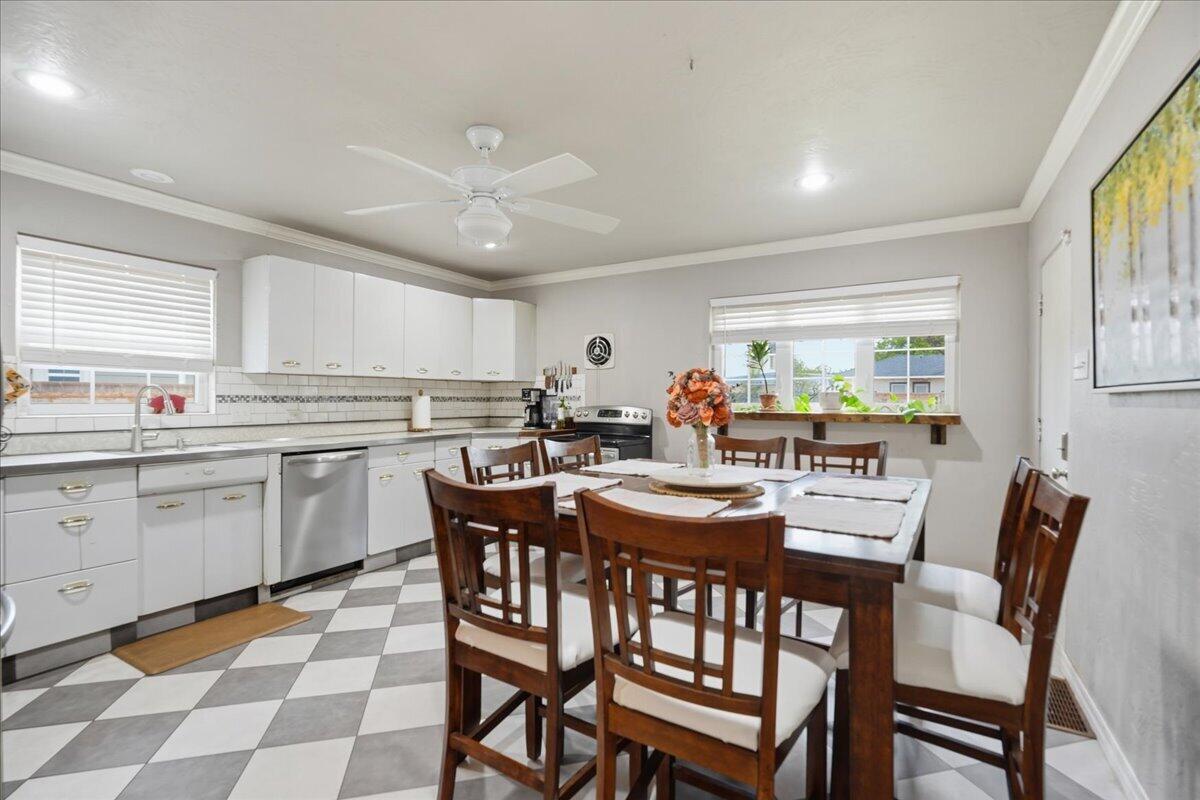 3607 27th Street Lubbock, TX 79410 - Photo 13 of 30 a kitchen with a dining table chairs and white appliances