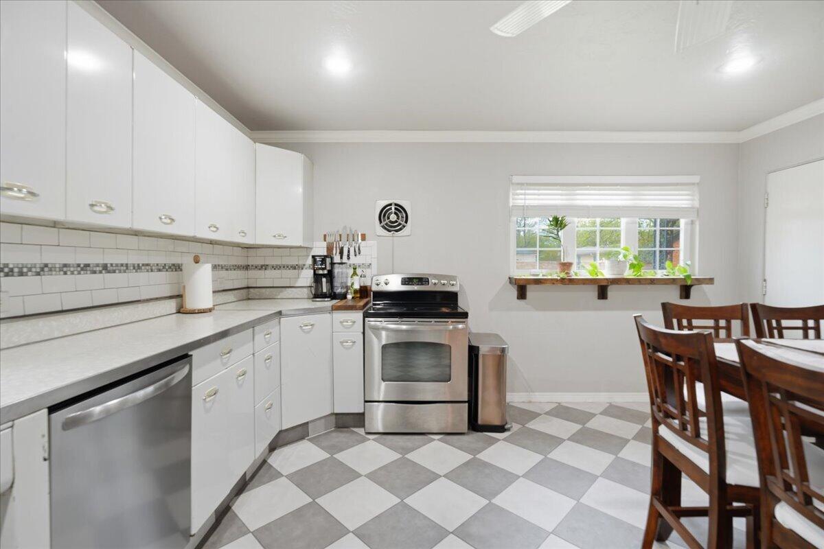 3607 27th Street Lubbock, TX 79410 - Photo 14 of 30 a kitchen with granite countertop a sink appliances and cabinets