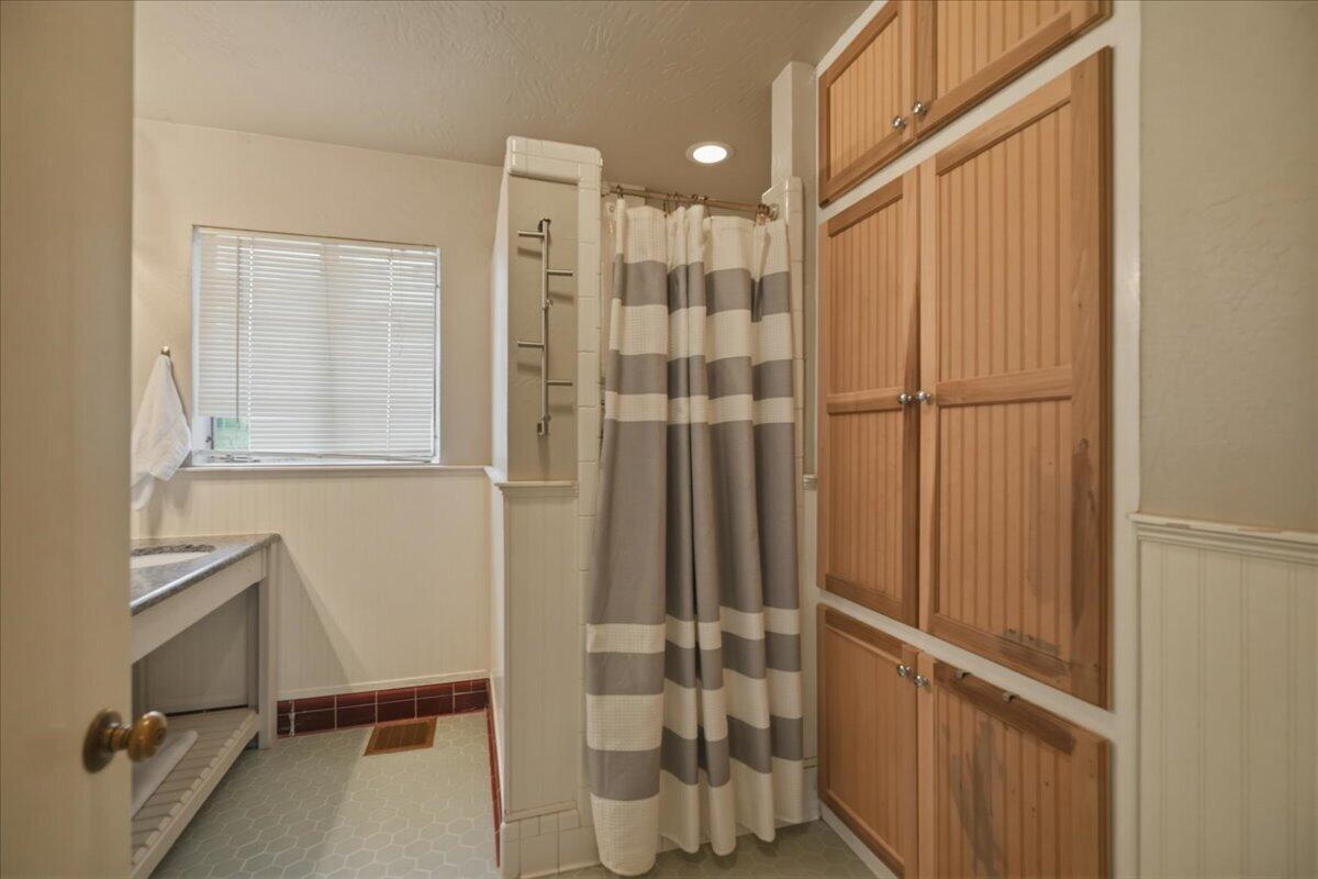 3607 27th Street Lubbock, TX 79410 - Photo 19 of 30 a bathroom with a shower and a sink