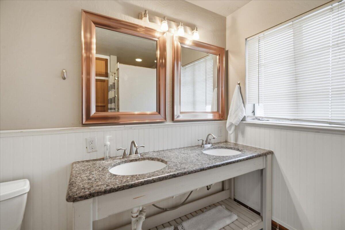 3607 27th Street Lubbock, TX 79410 - Photo 20 of 30 a bathroom with a granite countertop sink and a mirror