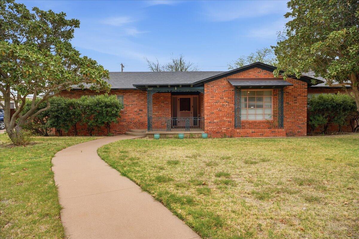 3607 27th Street Lubbock, TX 79410 - Photo 2 of 30 a front view of a house with garden