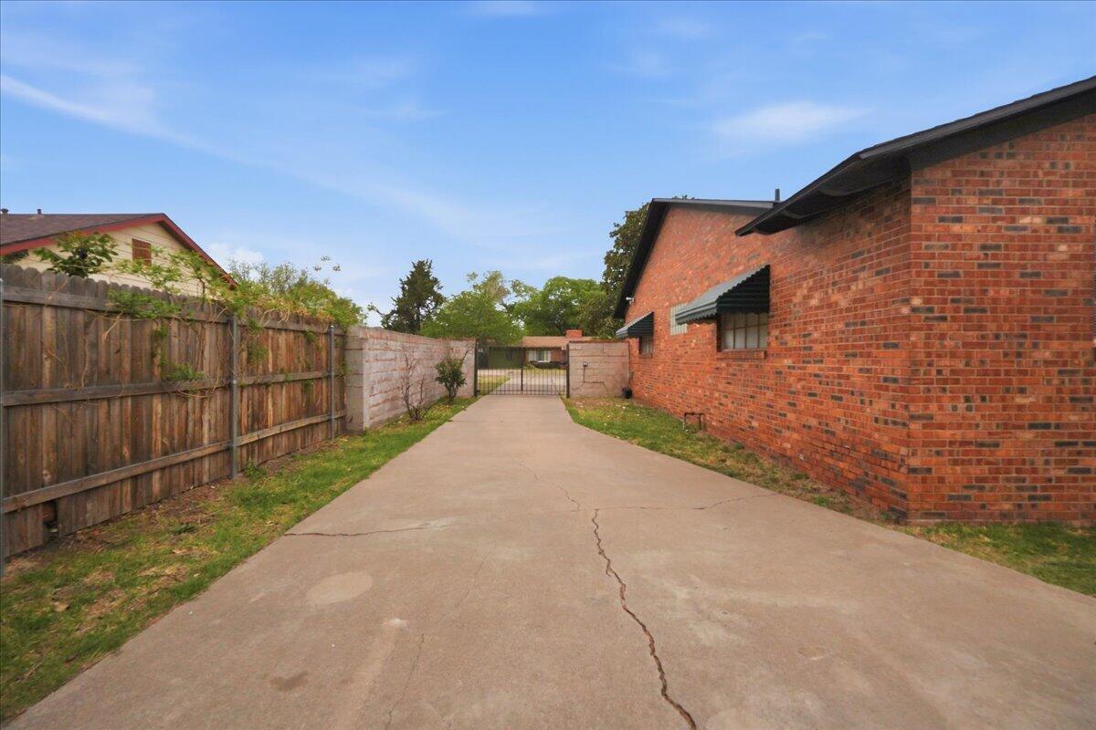 3607 27th Street Lubbock, TX 79410 - Photo 29 of 30 a view of a pathway both side of house with wooden fence