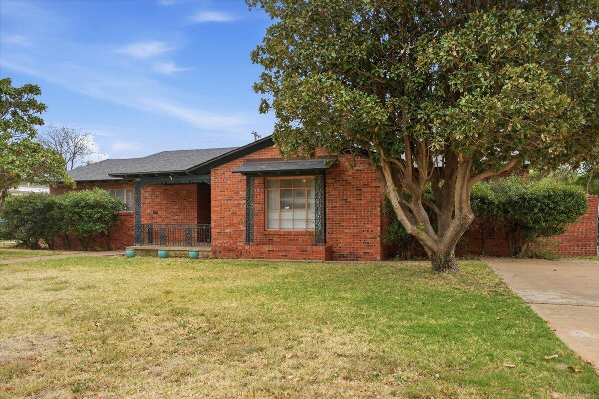 3607 27th Street Lubbock, TX 79410 - Photo 3 of 30 a front view of a house with a yard