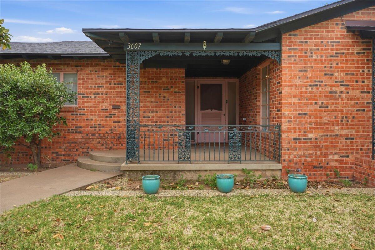 3607 27th Street Lubbock, TX 79410 - Photo 4 of 30 a front view of a house with garden