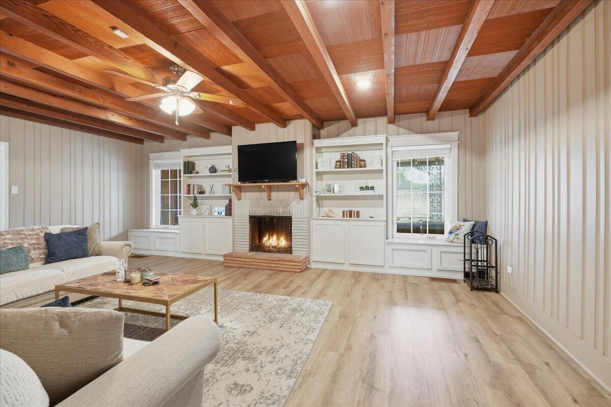 3607 27th Street Lubbock, TX 79410 - Photo 5 of 30 a living room with furniture a fireplace and a flat screen tv
