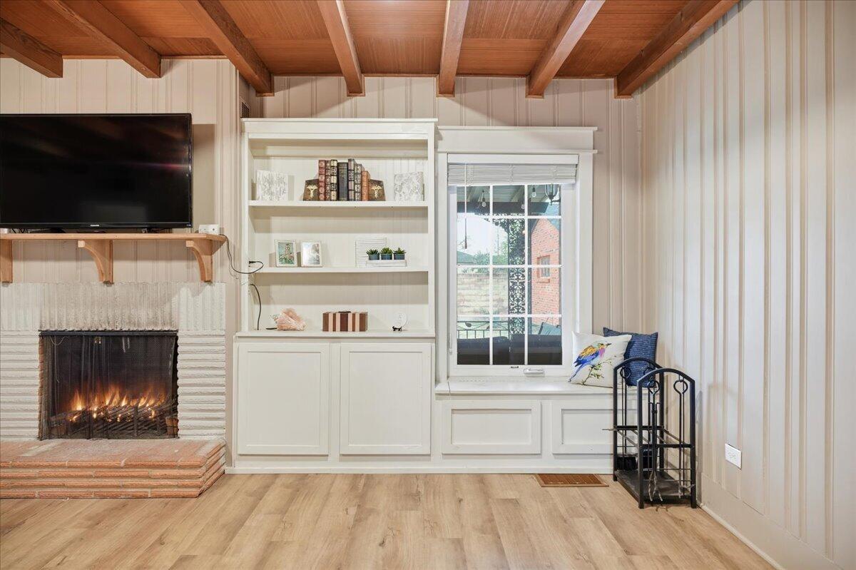 3607 27th Street Lubbock, TX 79410 - Photo 7 of 30 a living room with a flat screen tv and a fireplace