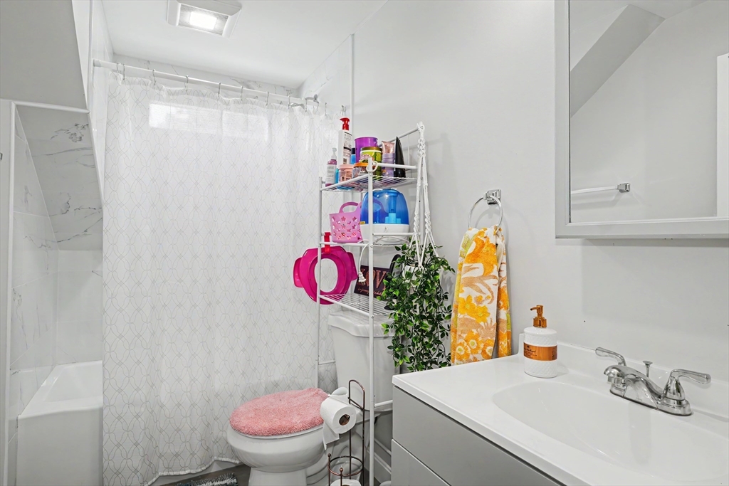 5 Eddy Street, Unit 2 Webster, MA 01570 - Photo 17 of 18 a bathroom with a sink mirror vanity and toilet