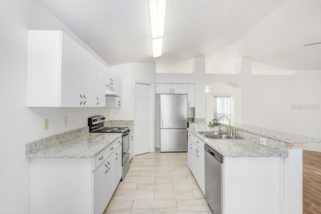 517 Royal Ridge Street Valrico, FL 33594 - Photo 11 of 30 a kitchen with a sink stove and refrigerator