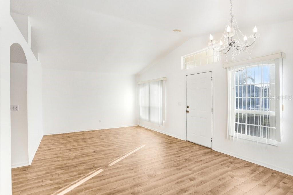 517 Royal Ridge Street Valrico, FL 33594 - Photo 4 of 30 a view of an empty room with wooden floor and a window