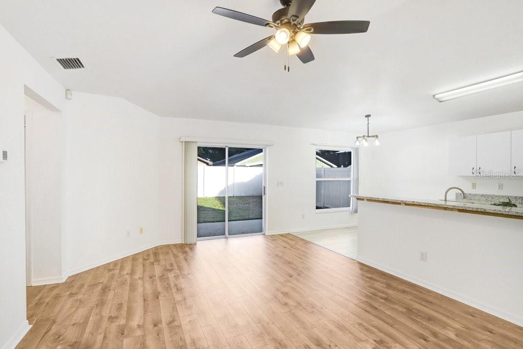 517 Royal Ridge Street Valrico, FL 33594 - Photo 8 of 30 a view of a kitchen with wooden floor and a ceiling fan
