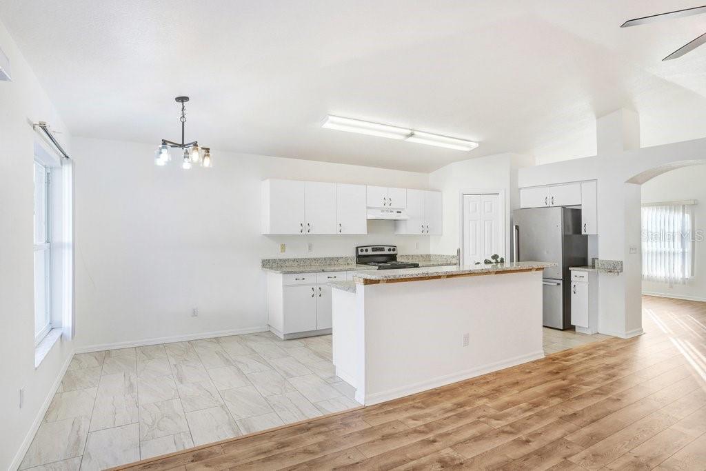 517 Royal Ridge Street Valrico, FL 33594 - Photo 10 of 30 a kitchen with stainless steel appliances granite countertop a sink stove and refrigerator