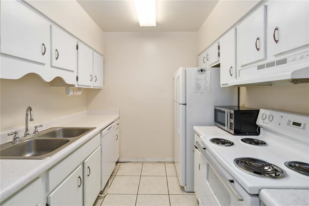 2500 Lee Road, Unit 244 Winter Park, FL 32789 - Photo 12 of 26 a kitchen with stainless steel appliances a white stove top oven a sink and a refrigerator