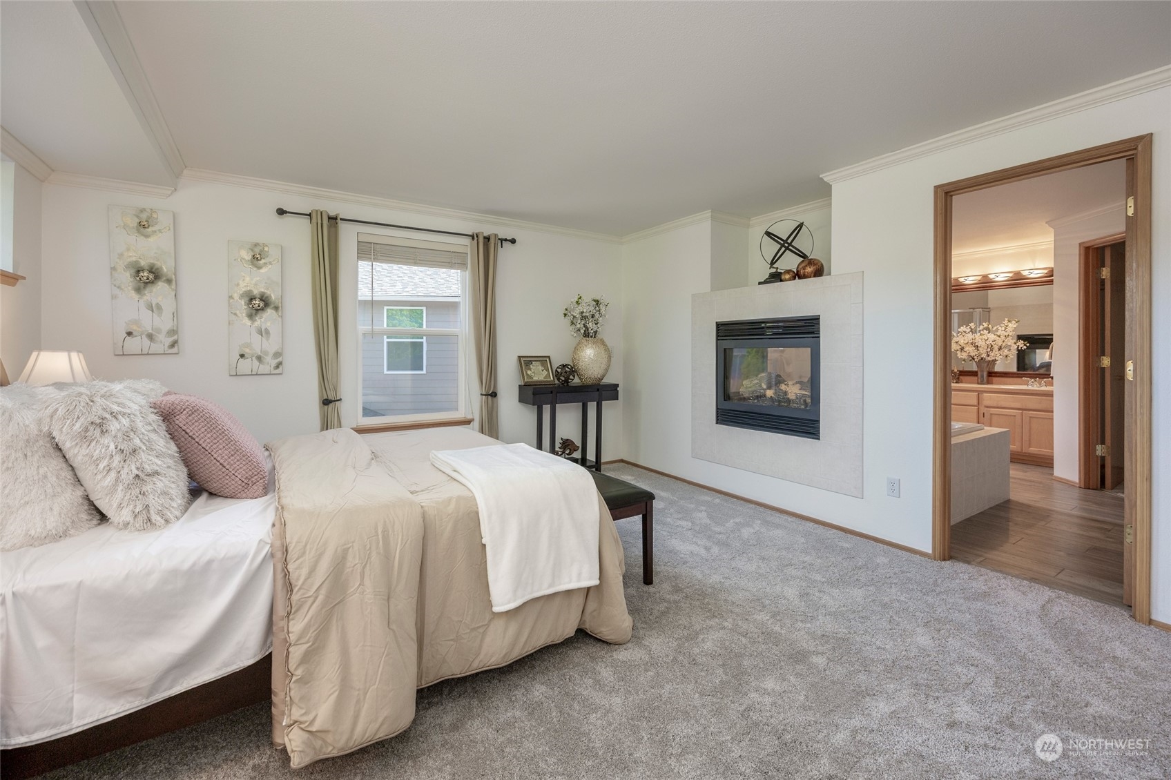 14439 Southeast 185th Place Renton, WA 98058 - Photo 21 of 36 a spacious bedroom with a bed and a fireplace