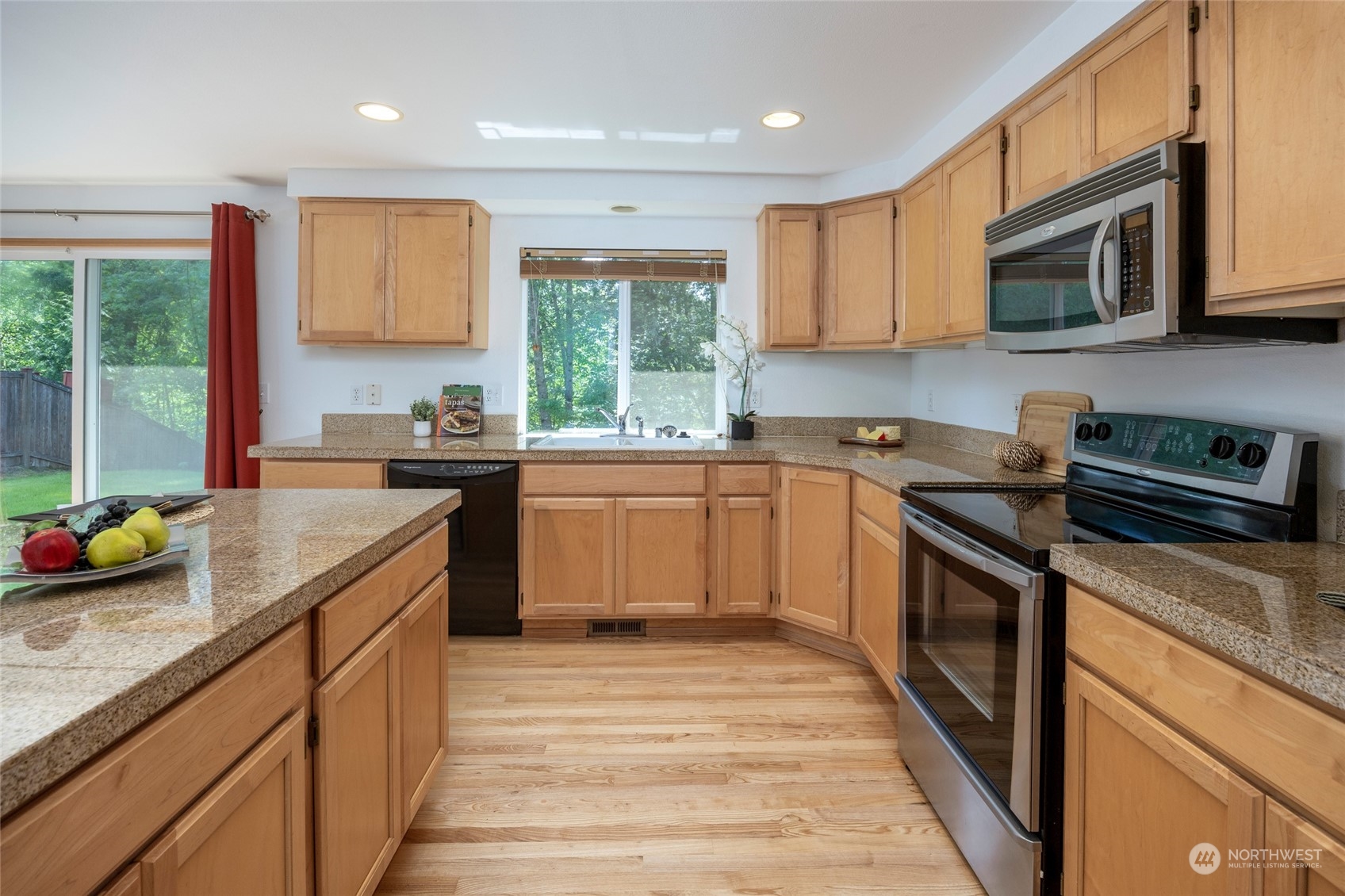 14439 Southeast 185th Place Renton, WA 98058 - Photo 9 of 36 a kitchen with stainless steel appliances granite countertop sink stove microwave and cabinets