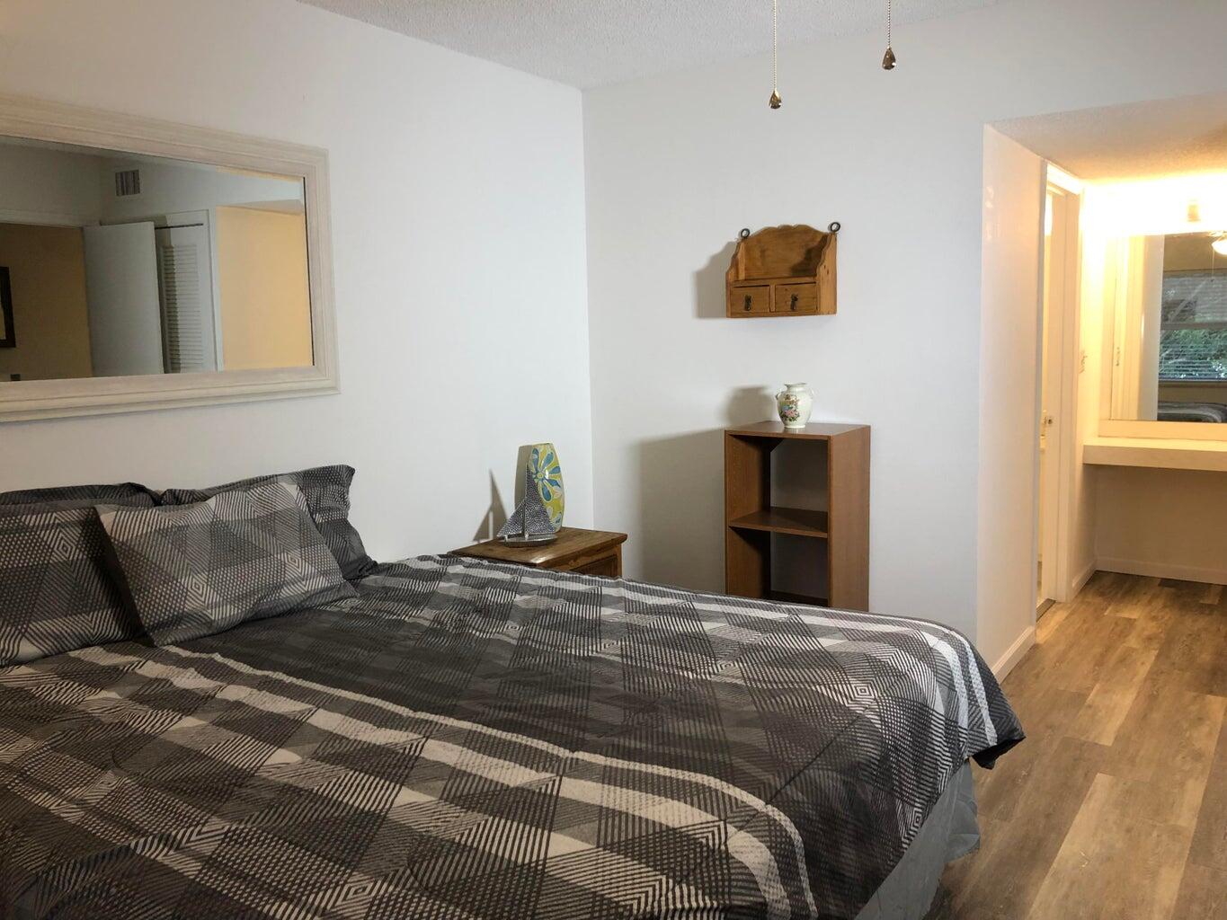 9826 Marina Boulevard, Unit 1023 Boca Raton, FL 33428 - Photo 13 of 31 a bedroom with a bed and a window