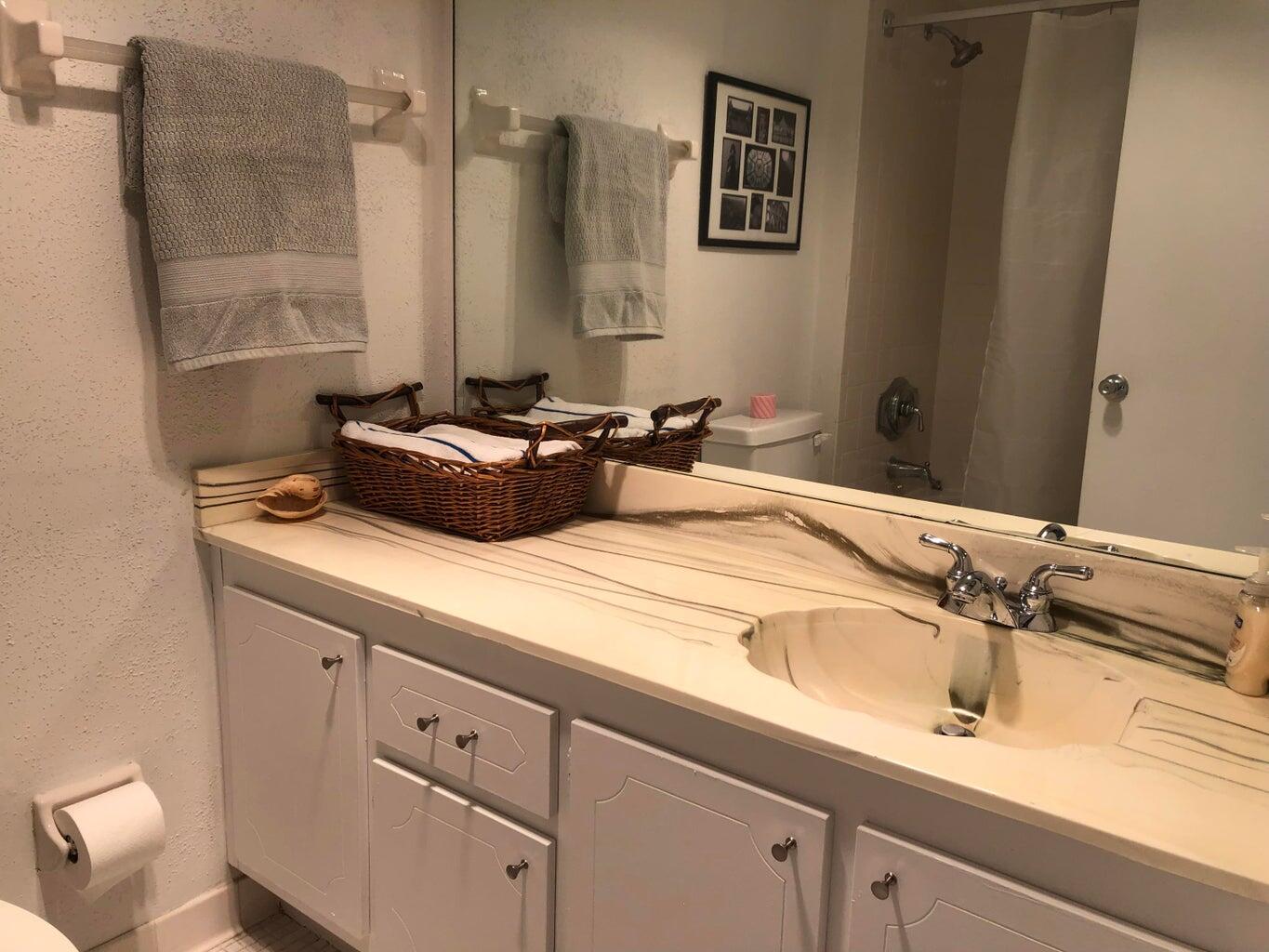 9826 Marina Boulevard, Unit 1023 Boca Raton, FL 33428 - Photo 16 of 31 a bathroom with a sink and a mirror