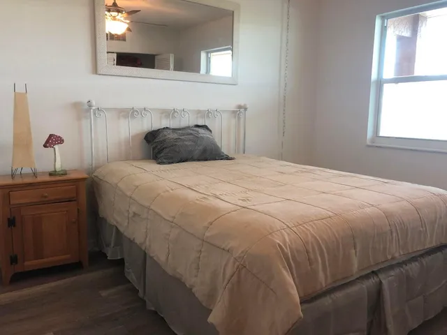 a bedroom with a bed and a window