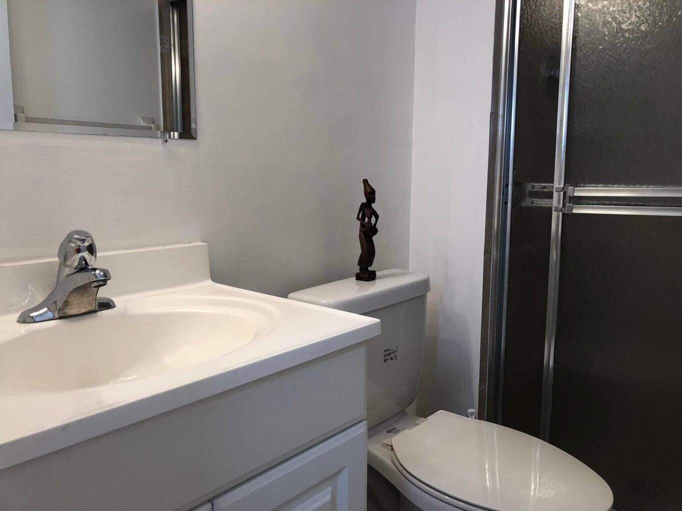 9826 Marina Boulevard, Unit 1023 Boca Raton, FL 33428 - Photo 19 of 31 a bathroom with a sink toilet and vanity