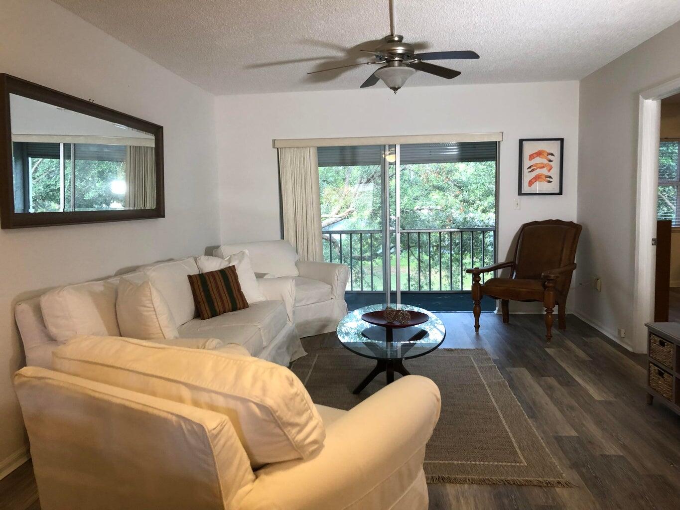 9826 Marina Boulevard, Unit 1023 Boca Raton, FL 33428 - Photo 2 of 31 a living room with furniture and a window