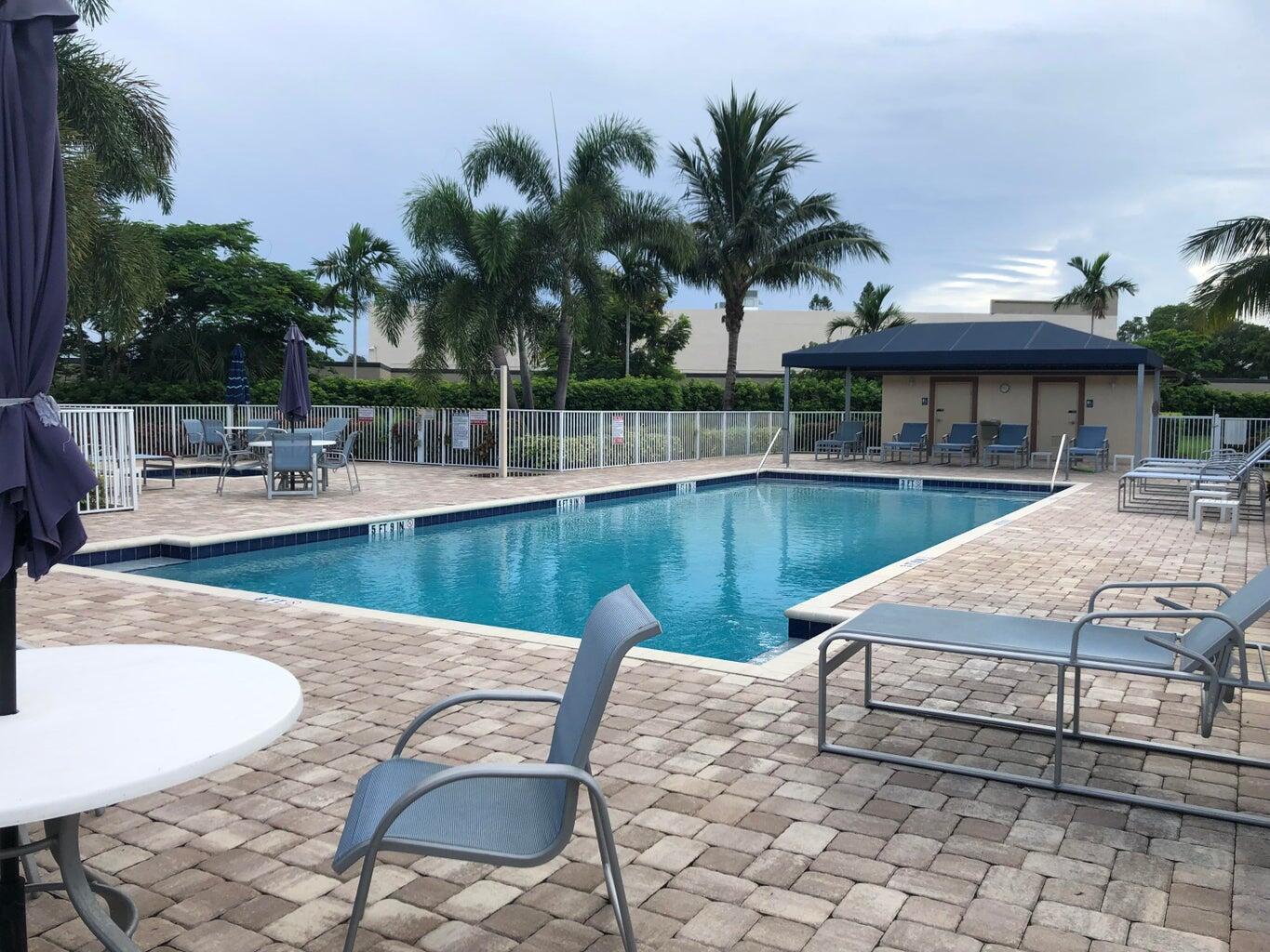 9826 Marina Boulevard, Unit 1023 Boca Raton, FL 33428 - Photo 22 of 31 a view of a swimming pool with a patio