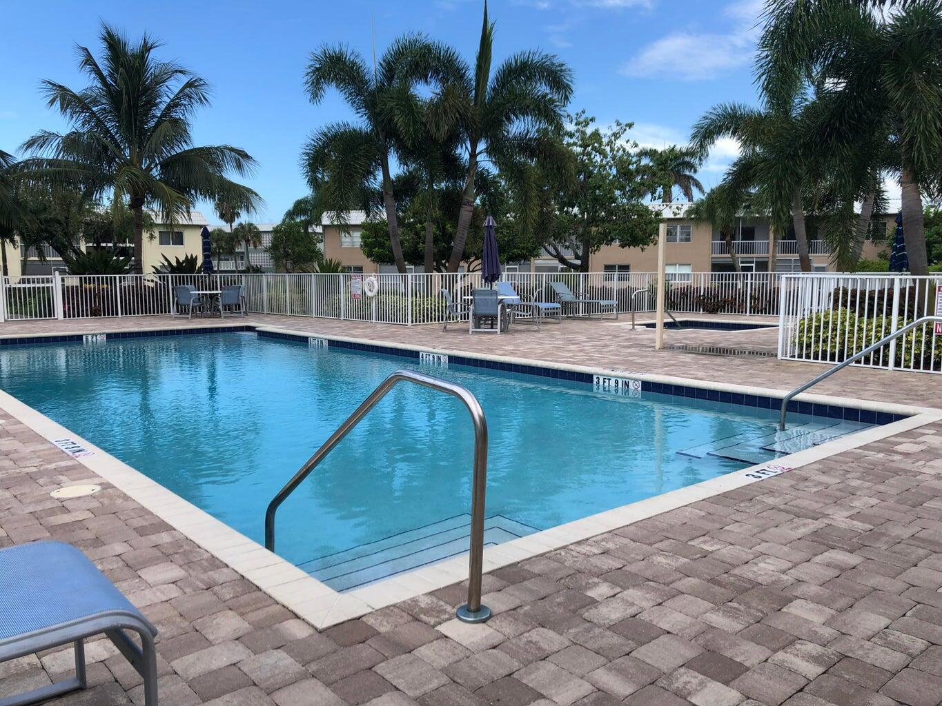 9826 Marina Boulevard, Unit 1023 Boca Raton, FL 33428 - Photo 23 of 31 a view of a swimming pool with a lounge chairs