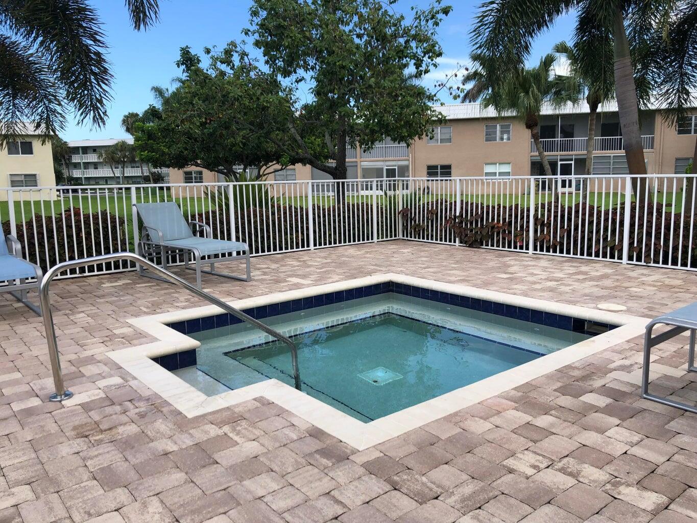 9826 Marina Boulevard, Unit 1023 Boca Raton, FL 33428 - Photo 24 of 31 a view of swimming pool with deck and a backyard