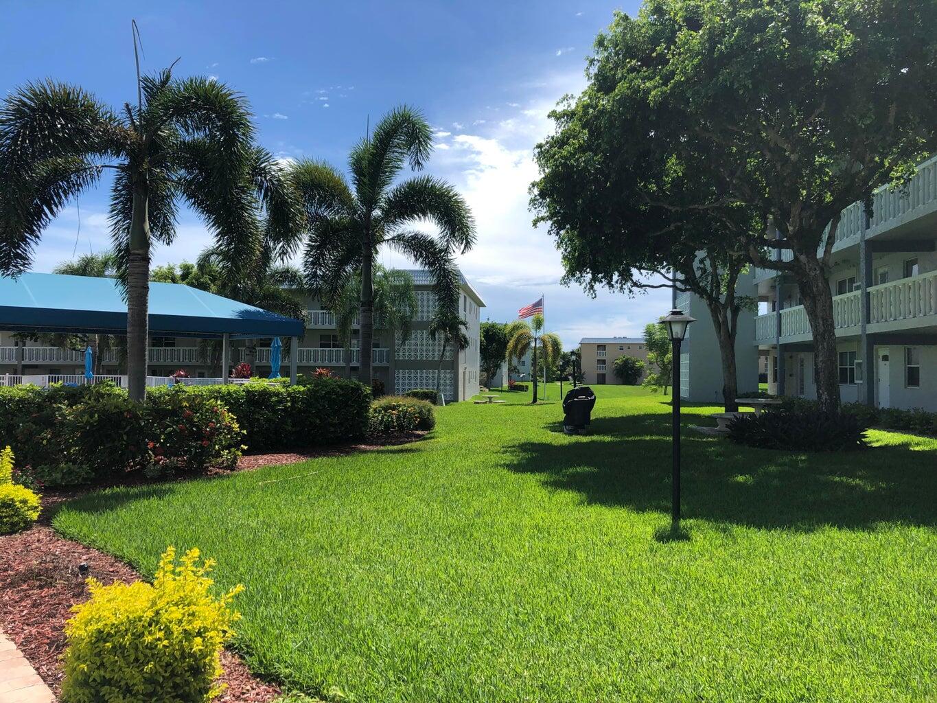 9826 Marina Boulevard, Unit 1023 Boca Raton, FL 33428 - Photo 25 of 31 a view of a backyard with palm trees