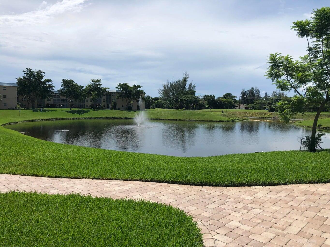 9826 Marina Boulevard, Unit 1023 Boca Raton, FL 33428 - Photo 28 of 31 a view of a lake with a garden